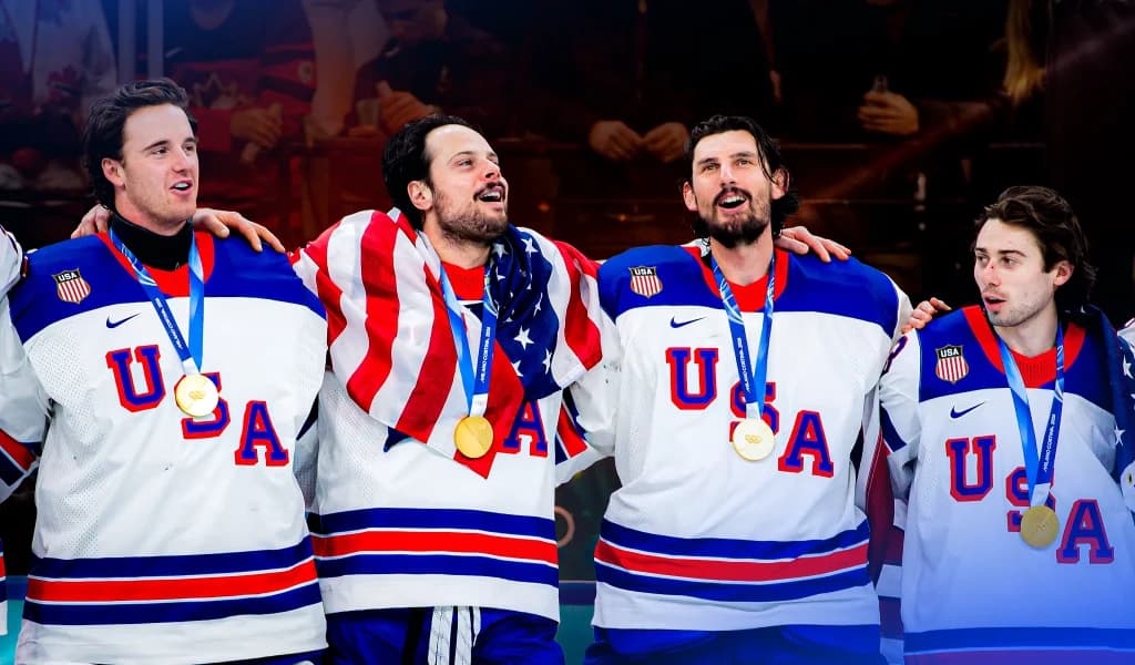Team USA hockey players celebrating together with gold medals.