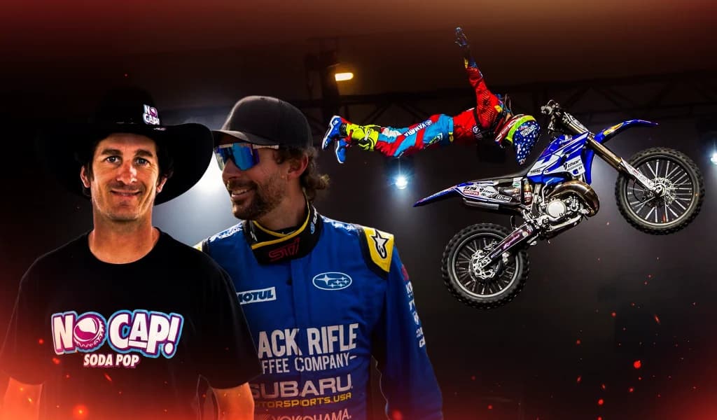 Two motocross riders, Jarryd McNeil and Travis Pastrana, posed together, with a midair stunt shown in the background.