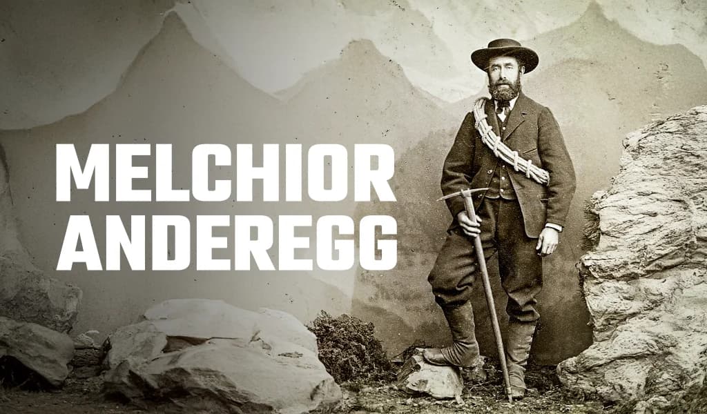 Historic photograph of mountaineer Melchior Anderegg standing with an ice axe in alpine terrain.